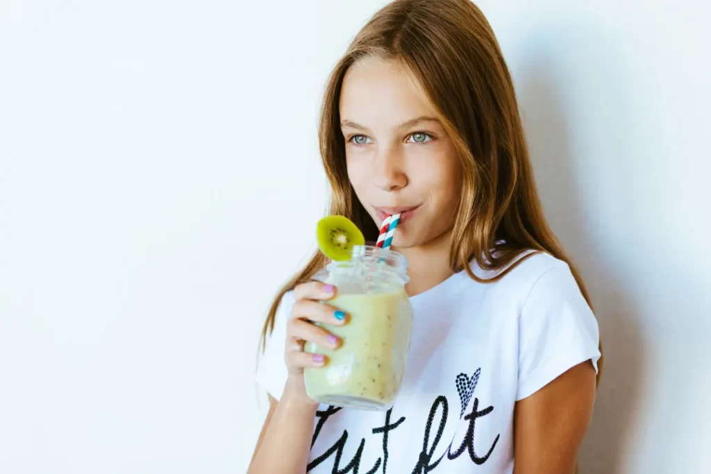 cute baby girl drinking a smoothie. 